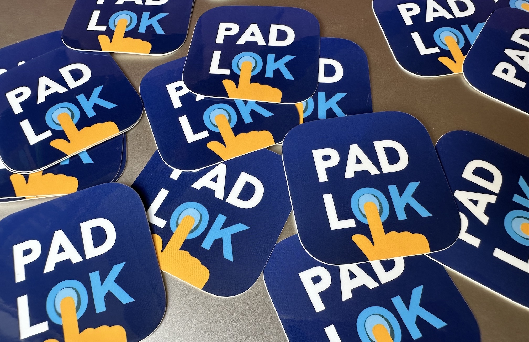 A bunch of Padlok App Icon stickers on a flat surface